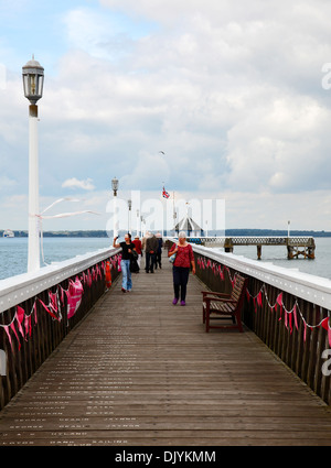 People on Yarmouth pier Yarmouth Isle of Wight Hampshire England Stock Photo