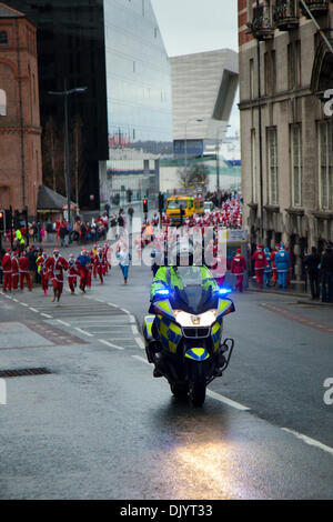 Police motorcyclists in Liverpool, Merseyside, UK  1st December, 2013. Policing the Liverpool Santa Dash starting at the Pier Head and attempting to break the Guinness World Record for the ‘Largest Santa Gathering’ which stands at a staggering 13,000 and also trying to raise to more than last year’s total of £5 million.  Festive Fun Run is backing the ITV Text Santa Appeal this year to help raise funds for Age UK, Anthony Nolan, Carers UK, Marie Curie Cancer Care, together for Short Lives and Whizz-Kidz. Stock Photo