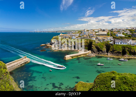 Cove and harbour of Port Isaac with arriving ship, Cornwall, England Stock Photo