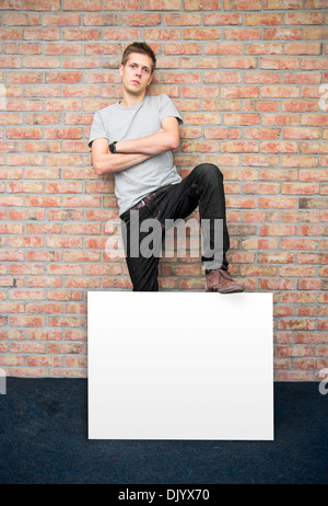 Young man holding blank whiteboard on business presentation Stock Photo