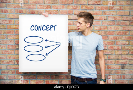 Young man holding whiteboard with diagram Stock Photo