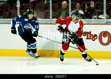 Dec. 19, 2010 - Las Vegas, Nevada, United States of America - Las Vegas Wranglers Defensemen Eddie DelGrosso (#21) is looking to pass while Idaho Steelheads Left Wing John-Scott Dickson (#33) tries to stop him during second period action of the Idaho Steelheads at Las Vegas Wranglers game at the Orleans Arena in Las Vegas, Nevada.  Las Vegas Wranglers lead the Idaho Steelheads 4 to Stock Photo
