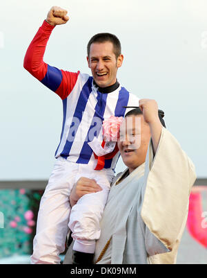 Dec. 26, 2010 - Chiba, Japan - Jockey MIRCO DEMURO(L) and grand champion Sumo wrestler HAKUHOU(R) celebrate after winning the 55thÃŠArima MemorialÃŠat Nakayama racecourse on December 26, 2010 in Funabashi, Japan. (Credit Image: © Shugo Takemi/Jana Press/ZUMAPRESS.com) Stock Photo