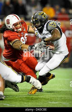 Dec. 28, 2010 - Orlando, Florida, United States of America - West Virginia Mountaineers running back Noel Devine (7) eludes North Carolina State Wolfpack defensive tackle Natanu Mageo (90) during the game between the West Virginia Mountaineers and the North Carolina State Wolfpack. The Wolfpack defeated the Mountaineers 23-7. (Credit Image: © Jerome Miron/Southcreek Global/ZUMAPRES Stock Photo