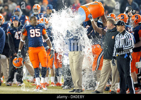 Dec. 30, 2010 - Bronx, New York, United States of America - Syracuse Orange head coach Doug Marrone gets the gatorade bucket  dumped on him by Syracuse Orange defensive end Chandler Jones (99), Syracuse Orange linebacker Marquis Spruill (11) and Syracuse Orange wide receiver Steve Rene (30) celebrating the Pinstripe Bowl Victory..Final Score of the New Era Pinstripe Bowl at Yankees Stock Photo