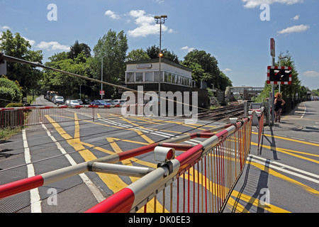 Railway level crossing at Brockenhurst station, with gates lowered Stock Photo