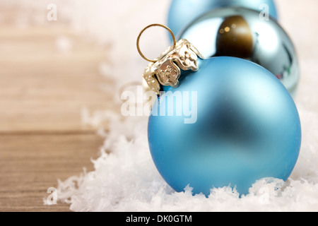 christmas decoration with wooden background, snow, christmas baubles blue and silver Stock Photo