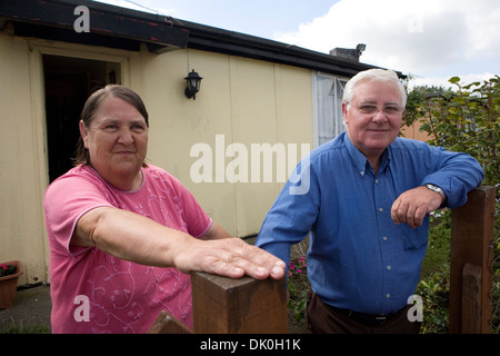 Jim and Christine Gallagher in front of their English Heritage listed prefab at the Excalibur estate in Catford. Stock Photo