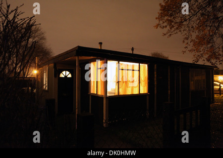 A uni-seco post-war prefab, from 1946, at night on the Excalibur Estate, Catford, Lewisham, London, UK Stock Photo