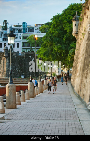 Strollers below 'La Muralla' (The Wall), Paseo de la Princesa, Old San Juan, Puerto Rico Stock Photo