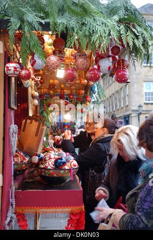 Market stall selling Christmas tree baubles at Bath Christmas Market, Bath, England, UK Stock Photo