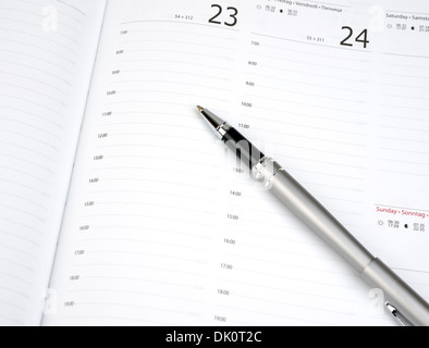 Pen on calendar page closeup Stock Photo