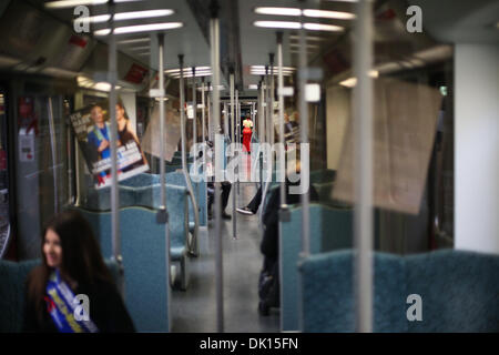 Berlin, Germany. 1st Dec, 2013. Volunteers wait for passengers on a S-Bahn inter-city train decorated with red ribbons and posters for World AIDS Day in Berlin, Germany, on Dec. 1, 2013. Credit:  Zhang Fan/Xinhua/Alamy Live News Stock Photo