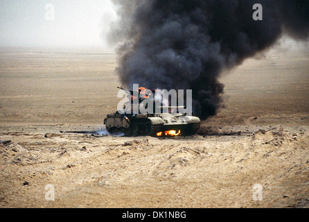 An Iraqi T-55 main battle tank burns after an attack by the 1st United Kingdom Armored Division during Operation Desert Storm February 28, 1991 in Kuwait. Stock Photo