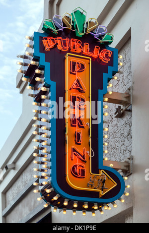 Neon Parking Sign At Parking Garage In City Downtown Stock Photo