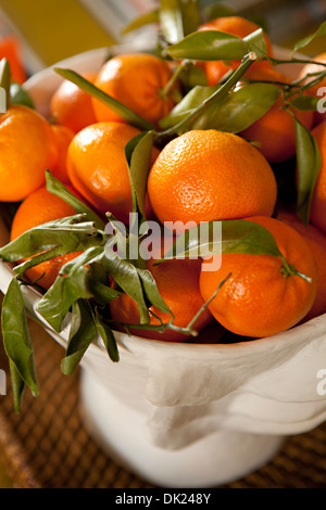 Close up high angle view of ripe orange tangerines in bowl Stock Photo