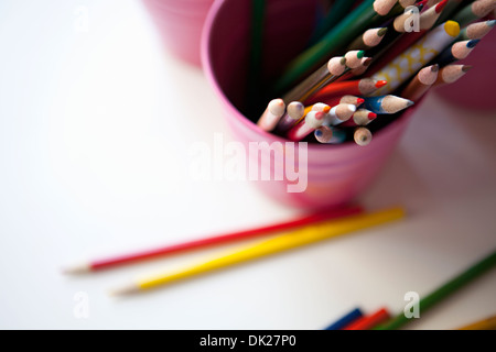 High angle view of multicolor art colored pencils in pink bucket Stock Photo