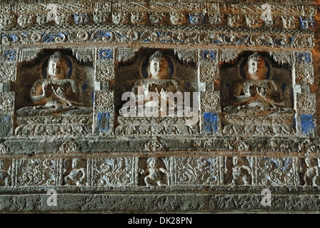 Cave 26: Frieze above pillars. Three Buddha figures seated in Padmasana on lotus. Ajanta Caves, Aurangabad, Maharashtra, India Stock Photo