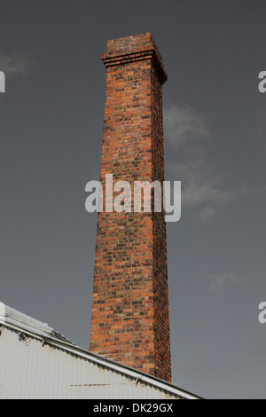 Tall brick chimney against the sky. Stock Photo