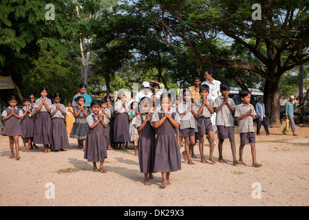 Rural Indian school children chanting vedas at Sri Sathya Sai Baba mobile outreach hospital service. Andhra Pradesh, India. Stock Photo