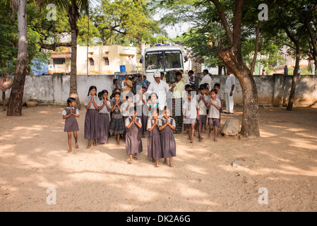 Rural Indian school children chanting vedas at Sri Sathya Sai Baba mobile outreach hospital service. Andhra Pradesh, India. Stock Photo