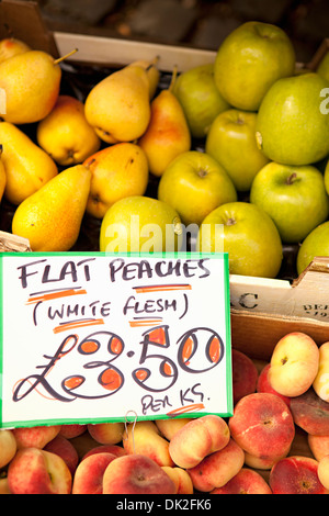 Close up high angle view of organic apples, apricots and pears with price sign at farmer’s market Stock Photo