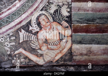 Cave 1 : Painting in the central hall. Picture shows flying figure holding a stalk of lotus. Ajanta Caves, Aurangabad, Maharasht Stock Photo