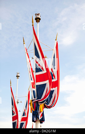 Low angle view of patriotic Union Jack British Flags flying at Buckingham Palace, London, England, United Kingdom Stock Photo