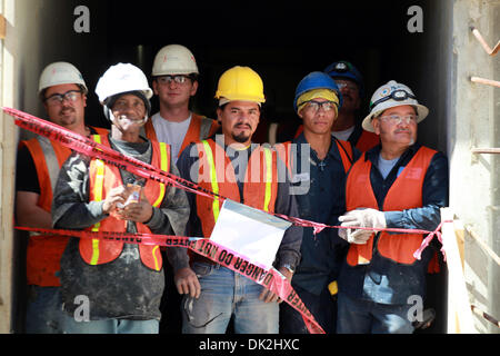 Feb. 15, 2011 - Miami, FL - Florida, USA - United States - 021011 (Allen Eyestone/The Palm Beach Post) MIAMI FL... Construction workers at the new Marlins' ballpark watch as Marlins players take batting practice. (Credit Image: © The Palm Beach Post/ZUMAPRESS.com) Stock Photo