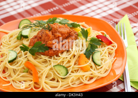 Spaghetti pasta with sauce and vegetables on table. Stock Photo