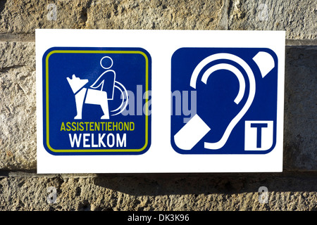 Pictograms welcoming wheelchair users with assistance dogs and hearing impaired persons to access public building Stock Photo