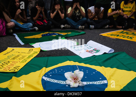 Brazil 2013 protests Young people cover their faces in shame for corruption in Brazilian Government, Brazil flag and flower