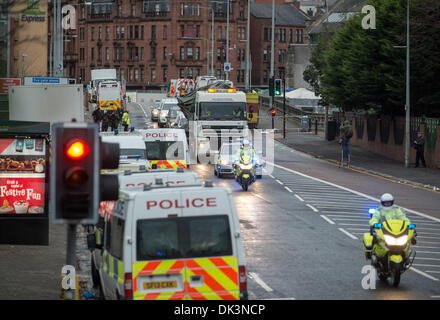 Glasgow, Scotland. 2nd December 2013. Police escort a lorry carrying the police helicopter from the The Clutha bar where it crashed last Friday  in Glasgow, Scotland. A ninth body has been recovered in the wreckage of Glasgow's Clutha pub which was destroyed when a police helicopter crashed on to the roof of it on Friday night. Credit:  Sam Kovak/Alamy Live News Stock Photo