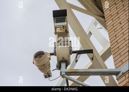 Security camera in a British city, shot against an overcast grey sky. Big Brother concept conceptual. Being watched. Stock Photo
