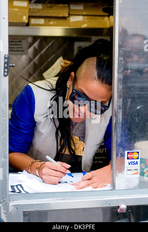 Cassie Ventura hands out icream sandwiches from Coolhaus ice cream cart in Manhattan New York City USA - 23.04.12 Stock Photo