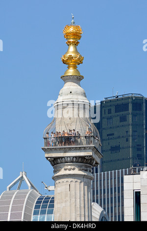 Tourists on the viewing platform at the top of the Monument column commemorating the Great Fire of London Stock Photo