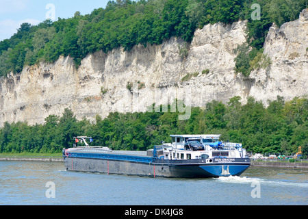 Long motor barge on Albert Canal in the St Pietersberg limestone cutting just after junction with the River Meuse Albert Canal near Lanaye in Belgium Stock Photo