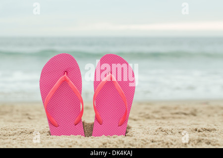 Pink sandals in the sand Stock Photo