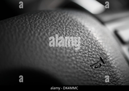 Close up shot of the horn button on a car's steering wheel Stock Photo