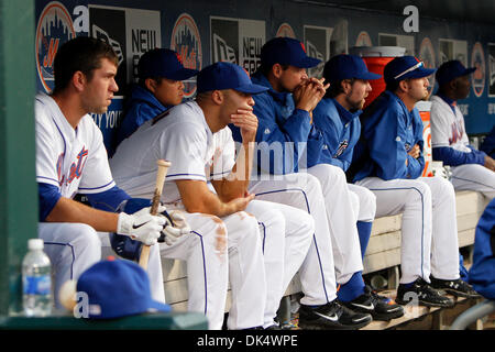 Apr. 14, 2011 - Corona, New York, U.S - New York Mets catcher Josh Thole (30), New York Mets right fielder Scott Hairston (12), New York Mets second baseman Chin-lung Hu (25), New York Mets starting pitcher Chris Young (55), New York Mets starting pitcher R.A. Dickey (43), New York Mets starting pitcher Jonathon Niese (49), and New York Mets first base coach Mookie Wilson (1) sit i Stock Photo