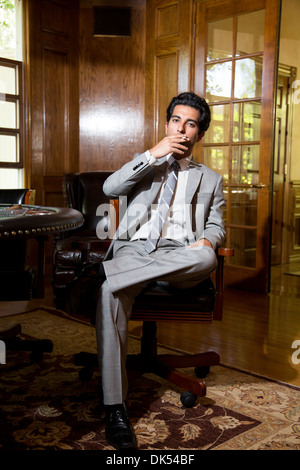 Man in a suit smoking a cigarette Stock Photo