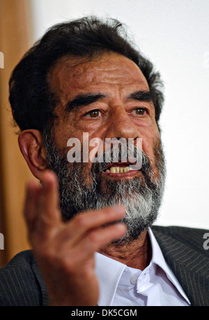 Former President of Iraq, Saddam Hussein gestures during his initial interview by a special tribunal after being captured July 2004 in Baghdad, Iraq. Stock Photo