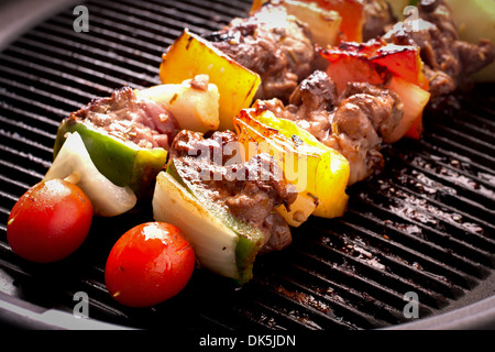 Grilling skewers barbecue with meat and vegetables on electric grill. Stock Photo