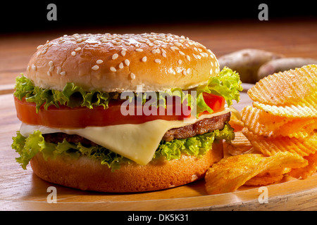 Burger with chips on wooden plates,and black background. Stock Photo