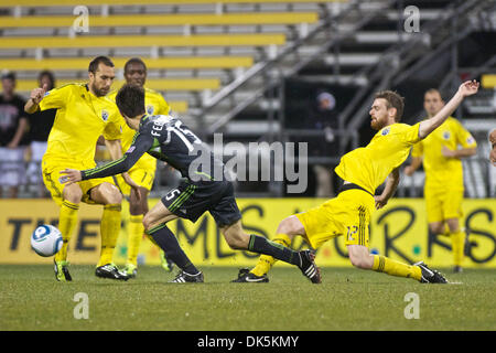 May 7, 2011 - Columbus, Ohio, U.S - Columbus Crew midfielder Eddie Gaven (12) slides to kick the ball away from Sounders FC midfielder Alvaro Fernandez (15) as Columbus Crew midfielder Dejan Rusmir (22) looks on during the second half of the game between Sounders FC and Columbus Crew at Crew Stadium, Columbus, Ohio.  Columbus and Seattle tied 1-1. (Credit Image: © Scott Stuart/Sout Stock Photo