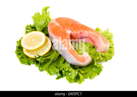Salmon steak on green salad leaves Stock Photo