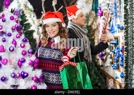 Man And Woman Shopping In Christmas Store Stock Photo