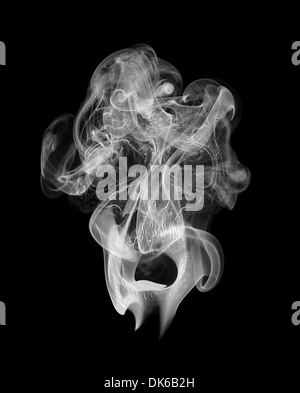 Illustration of a human scull appearing in the smoke isolated to black background. Stock Photo