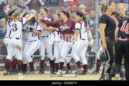 May 28, 2011 - Moline, Iowa, U.S. - Moline sophomore Jordan de los Reyes (13) gets mobbed by teammates at home plate, Sat. May 28, 2011, after hitting her second home run of the game during fourth inning action against United Township in the ballyhooed Class 4A regional softball final. (Credit Image: © John Schultz/Quad-City Times/ZUMAPRESS.com) Stock Photo