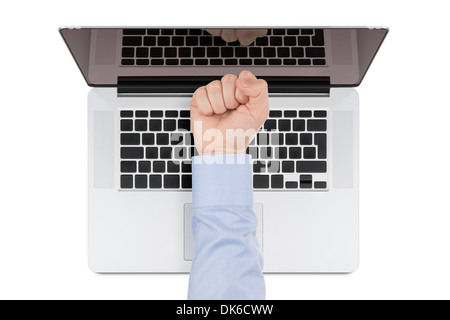 Top view of modern retina laptop with a man's fist pointing at the screen on white background. Stock Photo